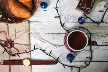 Christmas, cup of tea and a garland on the table
