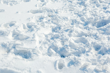Traces of people, animals and birds in the fresh white snow. Fresh snow fell. Snow texture for winter background.