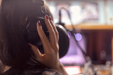 beautiful girl records a song in a professional Studio