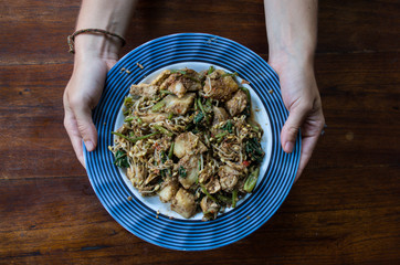 TIPAT CONTOK - mix steam vegetables, typical Balinese food, woman holding plate.