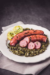 Kale with cooked sausage and potatoes