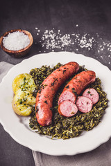Kale with cooked sausage and potatoes