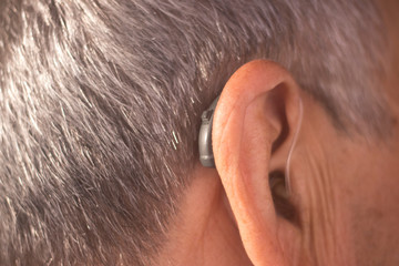 Deaf man hearing aid ear