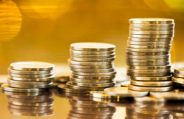 Gold investments -  precious metal savings, stack of money coins