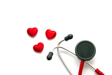 Diagnosis and treatment in cardiology. Medicine concept - Close up red stethoscope and heart isolated on white background. Copy space for text.