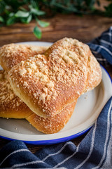 Sweet buns with cheese on wooden table.