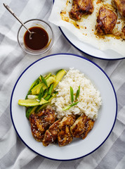Hoisin Chicken. Traditional Asian cuisine. Chicken with sauce, rice and pickled cucumbers.