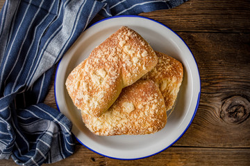 Sweet buns with cheese on wooden table.