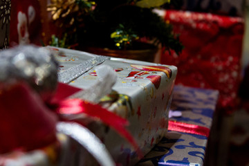 Festive christmas gifts are colourfully packed in a varicoloured paper..