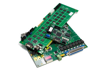 Set of electronic printed circuit boards with microchips and other components, angled view, isolated on white