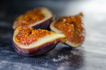 Figs on a dark wood background. selective focus on the figs slice