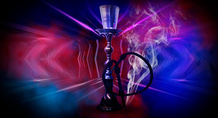 Hookah on an abstract neon background with smoke.