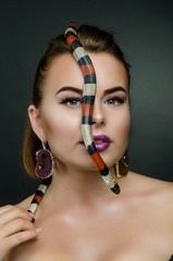 Perfect portrait sensual woman and king snake in the studio.