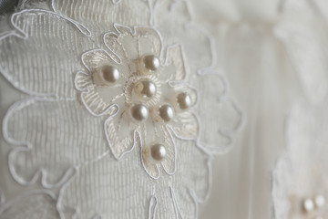 Detail of an elegant white wedding dress