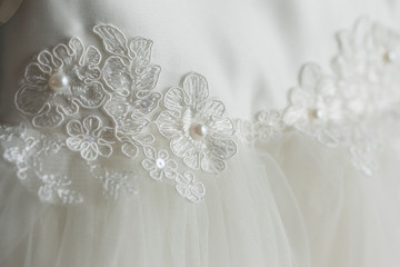 Detail of an elegant white wedding dress