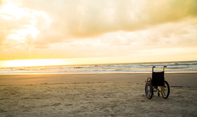 Fototapeta na wymiar sunset childlike wheelchair horizon sand