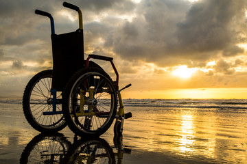 sunset childlike wheelchair horizon sand