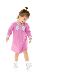 The little girl is walking fast.