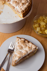 Piece of apple or pear cake, pie, with meringue on the plate. 