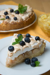 Piece of apple or pear homemade cake or pie, with meringue on the plate