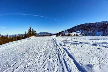 snow-covered glade and tourist hostel building in winter in Beskidy mountains . © GKor