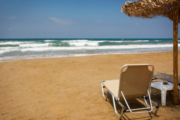 Beach chair by the sea in sunny day. Romantic mood. Travel paradise concept