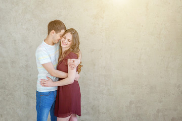 Romantic sexy couple in love having nice time together. Young woman hugging man, white light room background. Students, bride, groom, engagement, relationship, aspirations, supporting relying concept