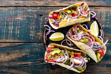 Mexican tacos with chicken meat, vegetables and fresh greens