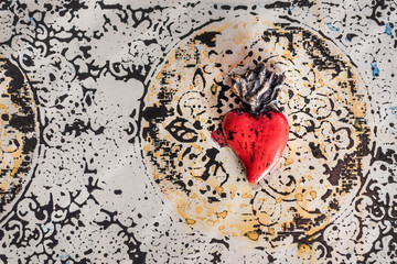 Red tin made heart. Antique and weathered heart found in Mexico