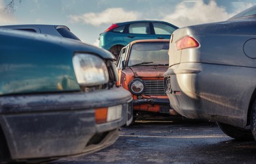 old used cars on scrap yard waiting to be disposed recycled