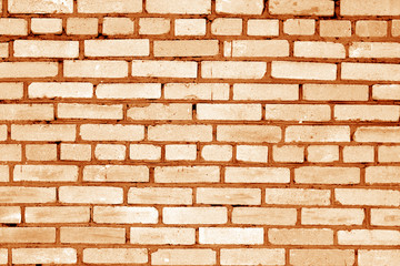 Old grungy brick wall surface in orange tone.