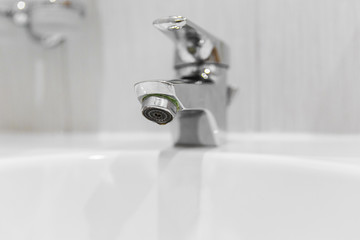 Gray dirty mixer in the bathroom. Blockage of mixer