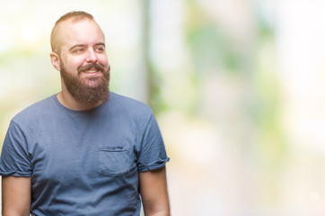 Young caucasian hipster man over isolated background looking away to side with smile on face, natural expression. Laughing confident.