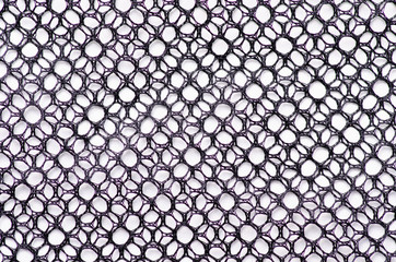 Black tracery mesh texture fabric macro on a white background