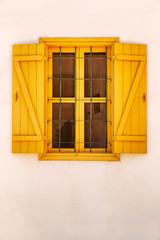 Window with colored shutters in the old house