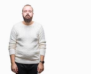 Fototapeta premium Young caucasian hipster man wearing winter sweater over isolated background with serious expression on face. Simple and natural looking at the camera.