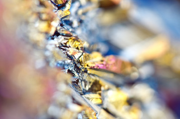 Beautiful colorful background of thin layer of titanium on the surface of quartz. Macro