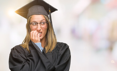 Young beautiful woman wearing graduated uniform over isolated background looking stressed and nervous with hands on mouth biting nails. Anxiety problem.