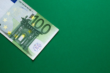 Money concept - 100 euro bill on green background. Win prize in casino.