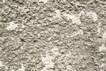Cracked grey paint on the wall background