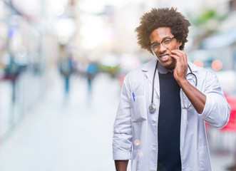 Afro american doctor man over isolated background touching mouth with hand with painful expression because of toothache or dental illness on teeth. Dentist concept.