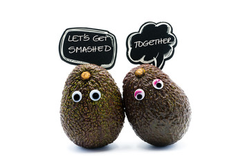 Romantic avocados couple with googly eyes and speech bubble as man and woman, funny food concept for creative projects