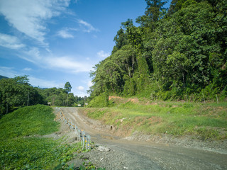 Landscape view with countryside road infected by landslide connecting Tawau and Keningau town during early morning in Sabah, Malaysia. This road also knows as Jalan Kalabakan-Sapulut.