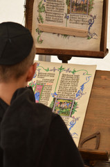 Young male medieval scribe make manuscript - calligraphy