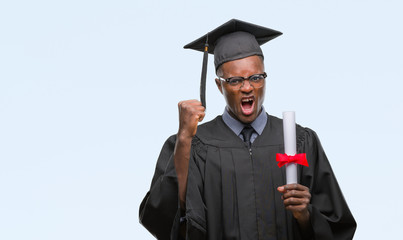 Young graduated african american man holding degree over isolated background annoyed and frustrated shouting with anger, crazy and yelling with raised hand, anger concept