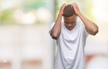 Young african american man over isolated background suffering from headache desperate and stressed because pain and migraine. Hands on head.