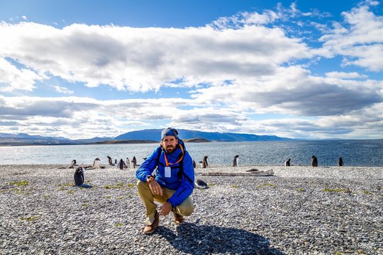 Homme au milieu des manchots en Patagonie Argentine