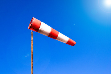 Airport windsock on clear blue sky background in windy weather indicate the local wind direction...