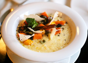 Photo of bright tasty healthy quinoa porridge with pumpkin