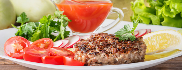 Chopped steak cutlet cooked on grill on white plate